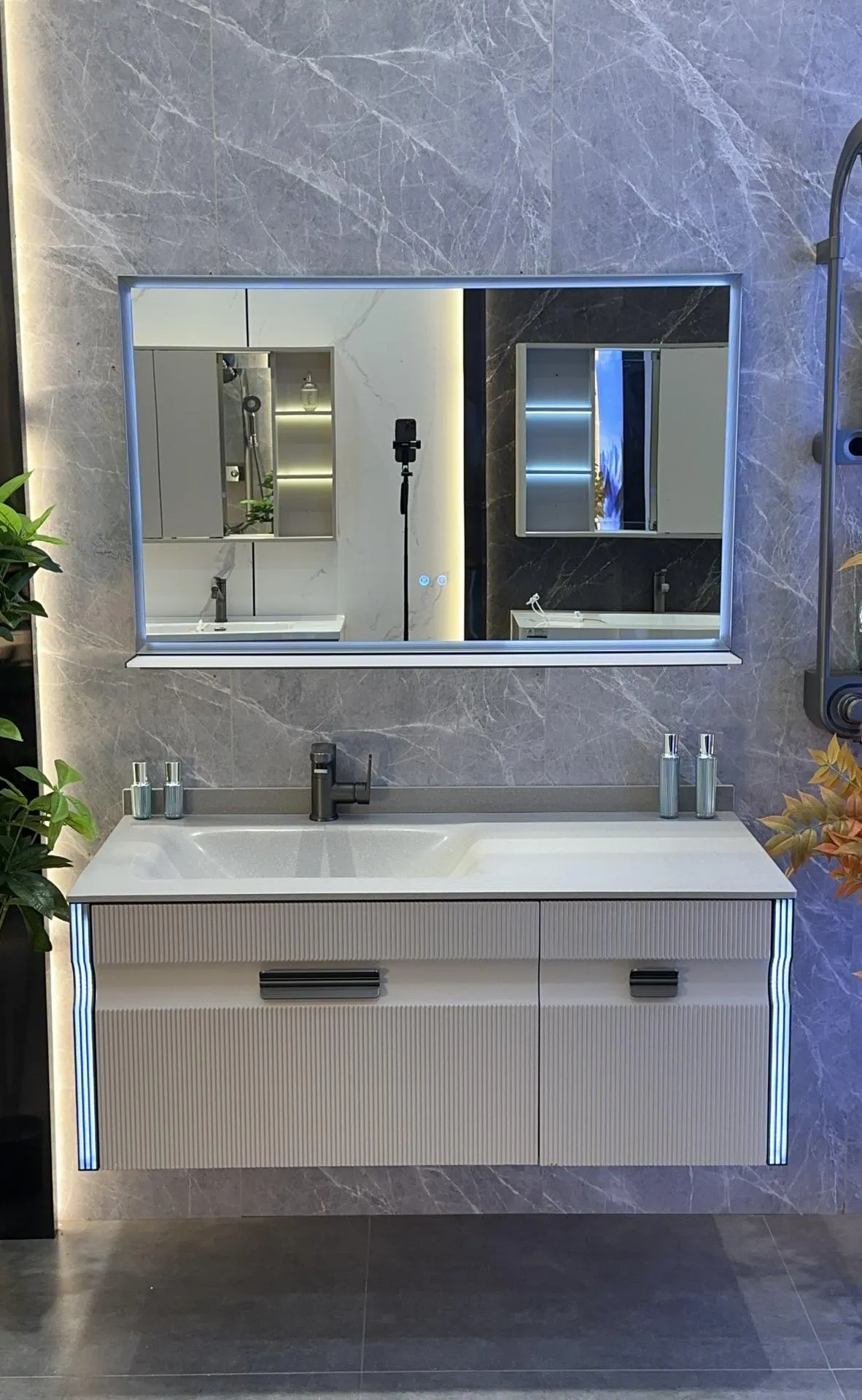 Aria 80 vanity: compact white hot-bent sintered stone basin on an oak-finish wall-hung cabinet with LED mirror.