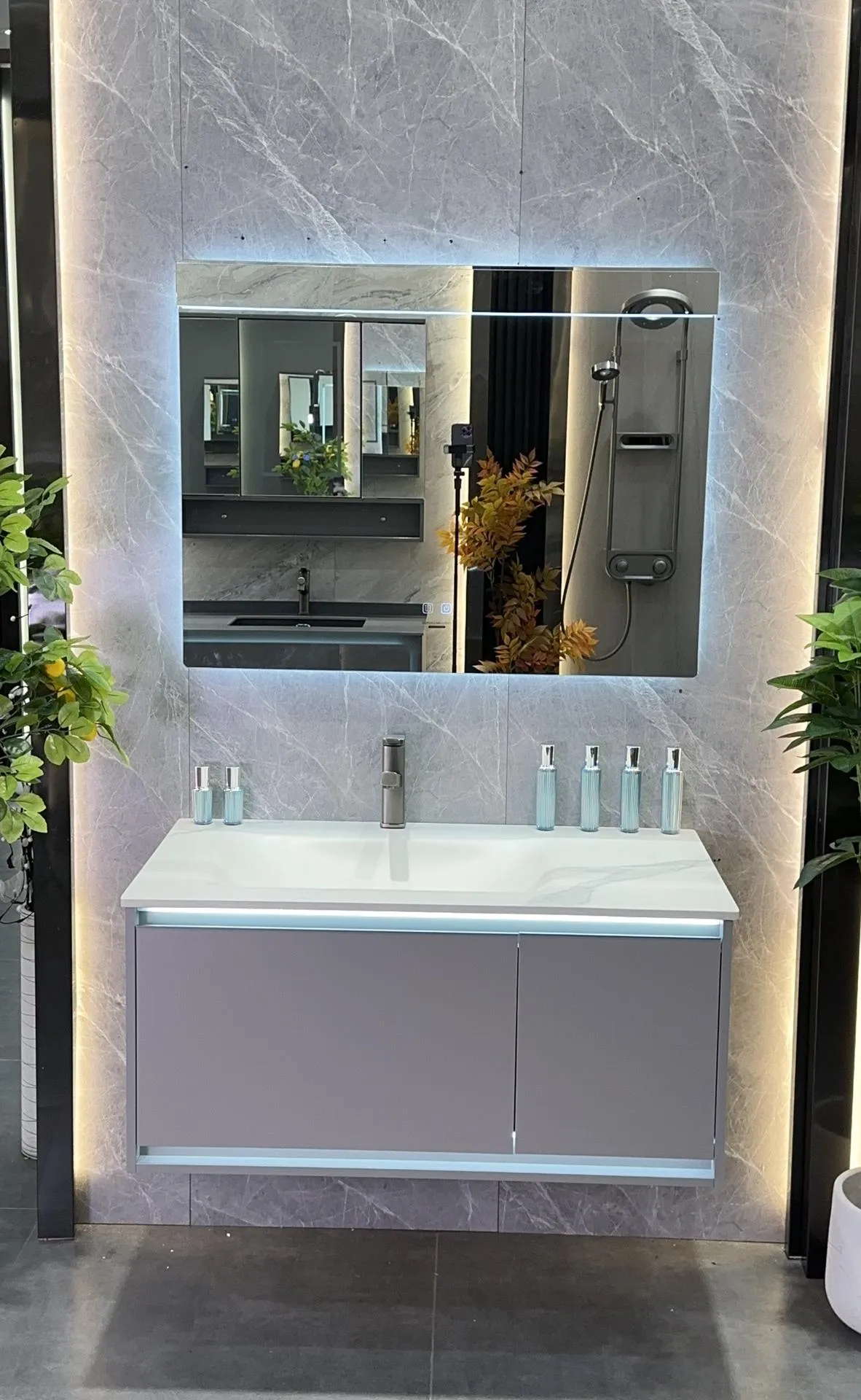 Vora Surfaces workshop: a hot-bent sintered stone basin vanity with one-piece basin and wall-hung cabinet, photographed in the factory showroom.